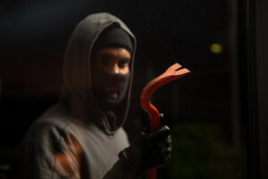 hooded hooligan in balaclava holding a crowbar bl utc